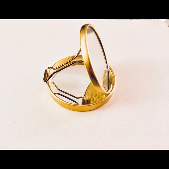 A gold pocket mirror. - Picture 1 of 4